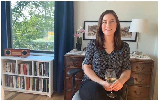 Photo of woman sitting in chair with glass of wine